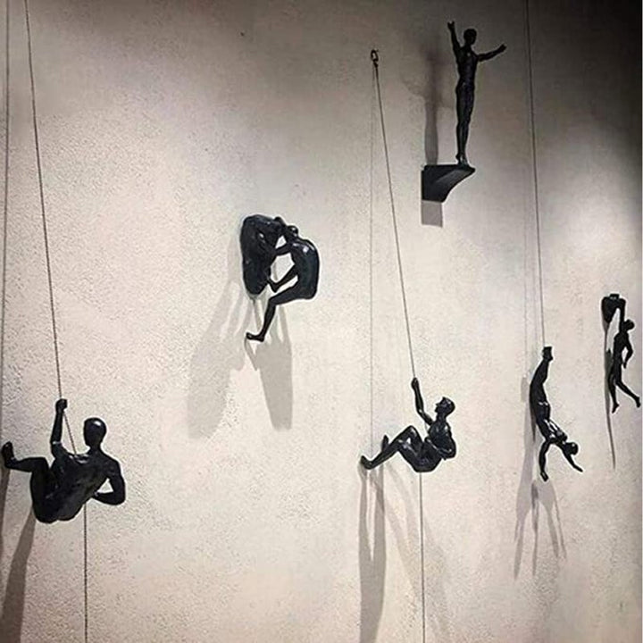 Climbing wall hanging statues