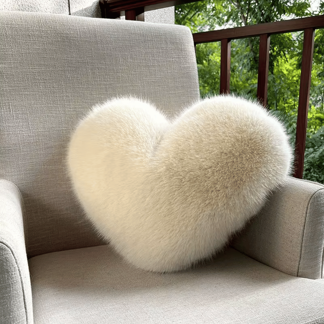 Soft decorative cushion in heart shape with plush texture