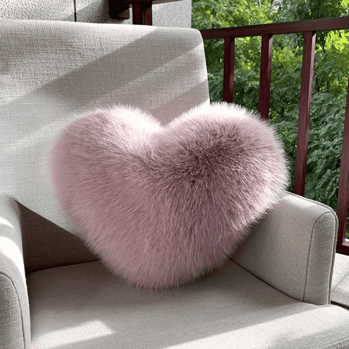 Soft decorative cushion in heart shape with plush texture