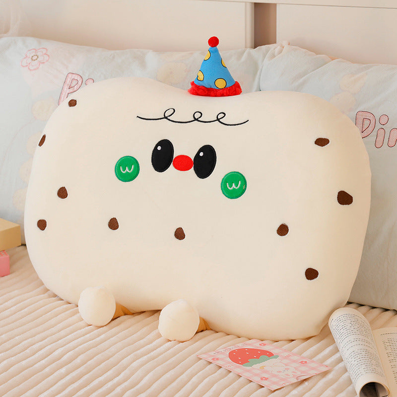 Plush pillow in cookie shape with cute face